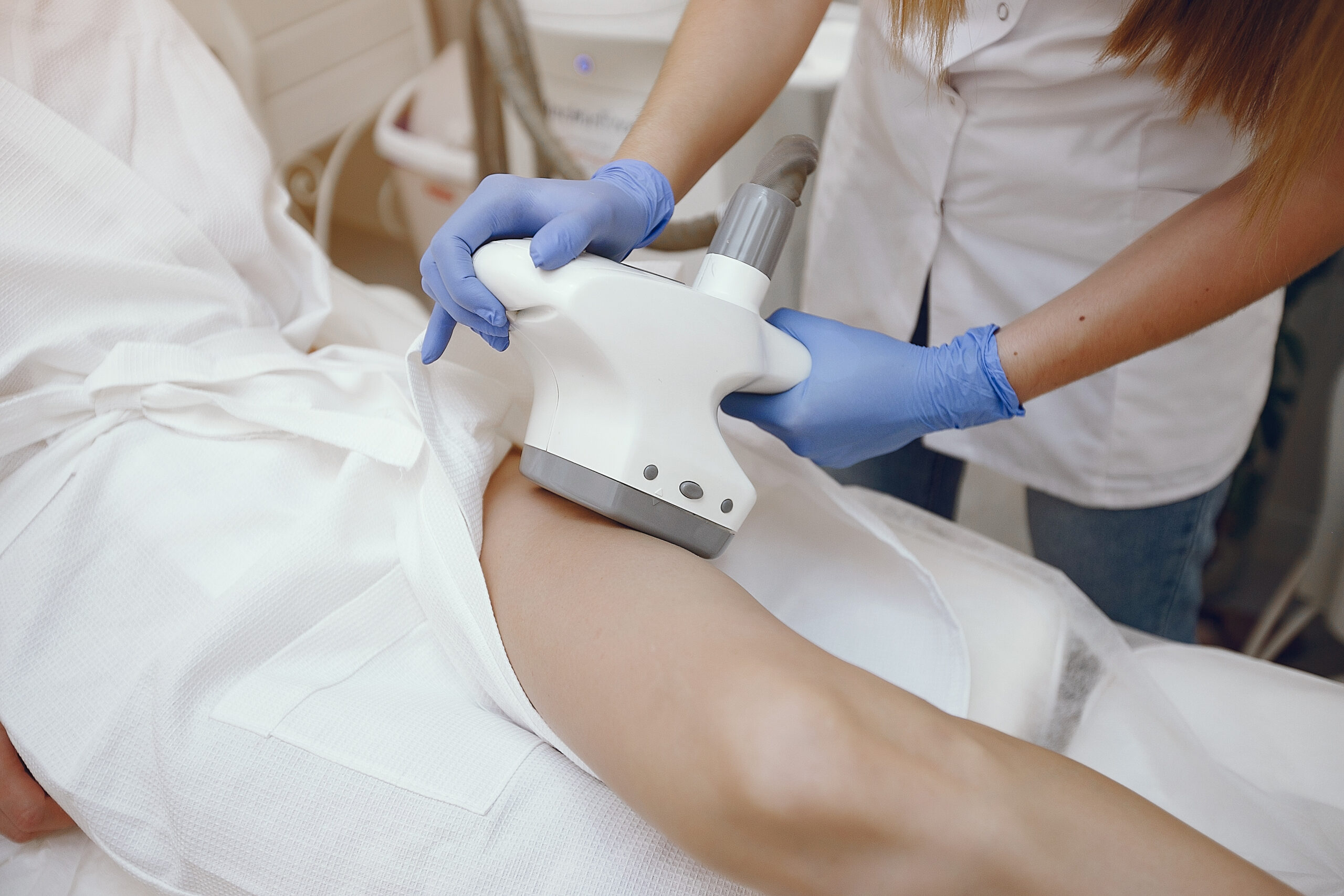 Cosmetologist use laser. Woman with cosmetologist. Lady in a beauty studio.